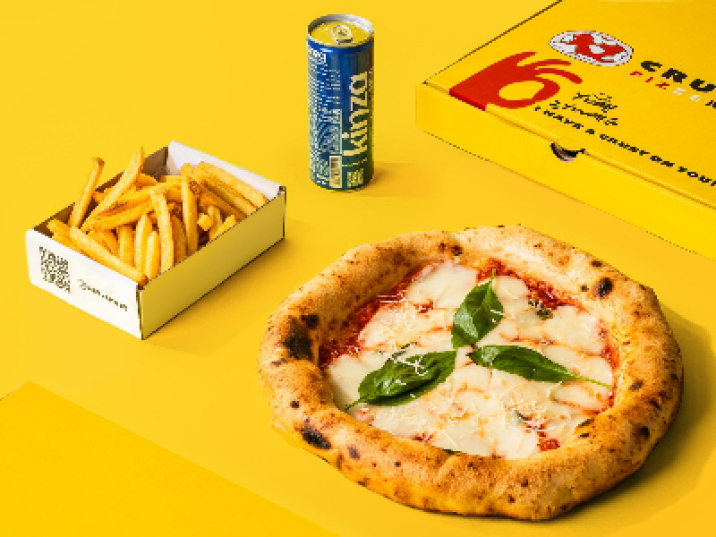 Pizza, fries, and a drink on a yellow background